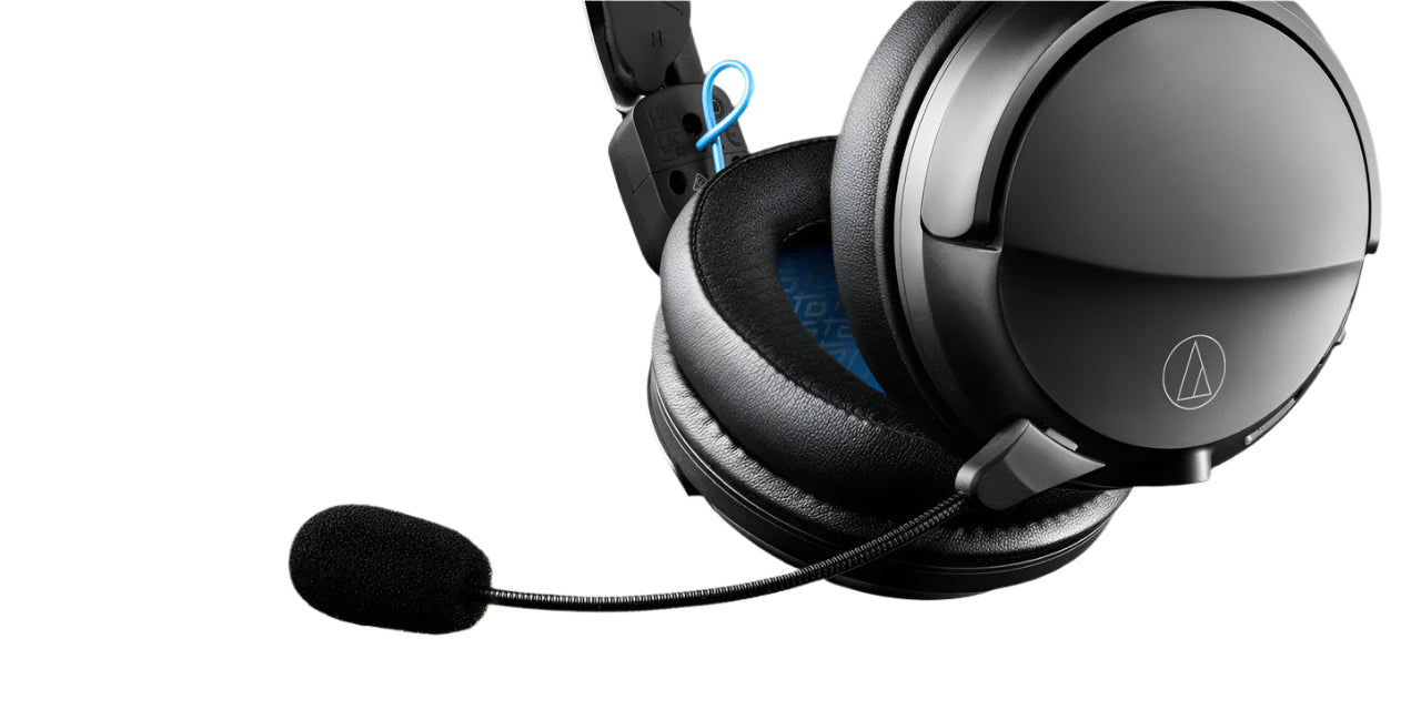 Black gaming headset with microphone on a beige background